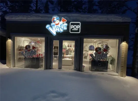 The Valle store with a POP by SkiStar sign in the snow on a winter evening